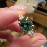 round brilliant cut madagascan teal sapphire trilogy engagement ring