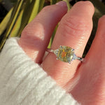 cushion cut yellow sapphire trilogy engagement ring in platinum