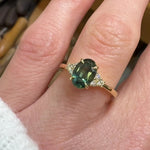 oval teal green sapphire and diamonds yellow gold engagement ring