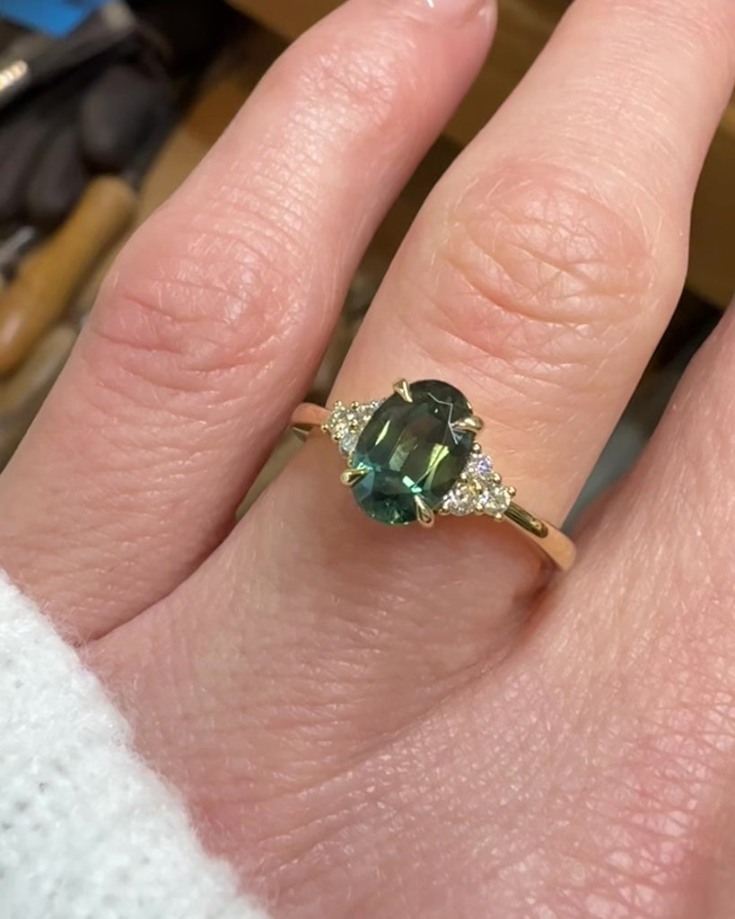 oval teal green sapphire and diamonds yellow gold engagement ring
