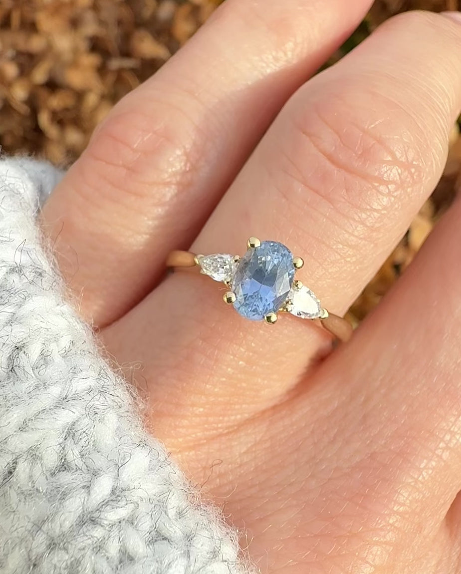 blue sapphire yellow gold trilogy engagement ring