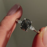 Platinum salt and pepper oval diamond engagement trilogy ring