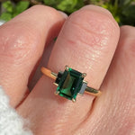 emerald cut emerald trilogy engagement ring set in yellow gold