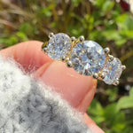 round brilliant cut lab grown diamond yellow gold trilogy engagement ring
