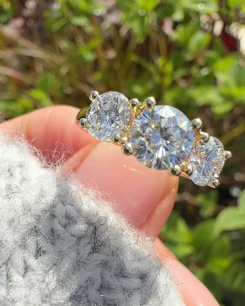 round brilliant cut lab grown diamond yellow gold trilogy engagement ring