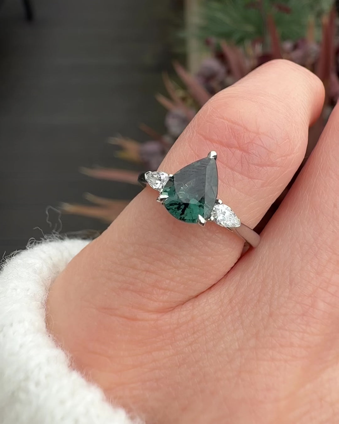 pear shape green teal sapphire trilogy engagement ring in platinum
