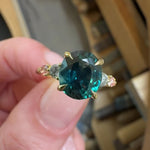 oval blue teal sapphire yellow gold engagement ring with four side stones