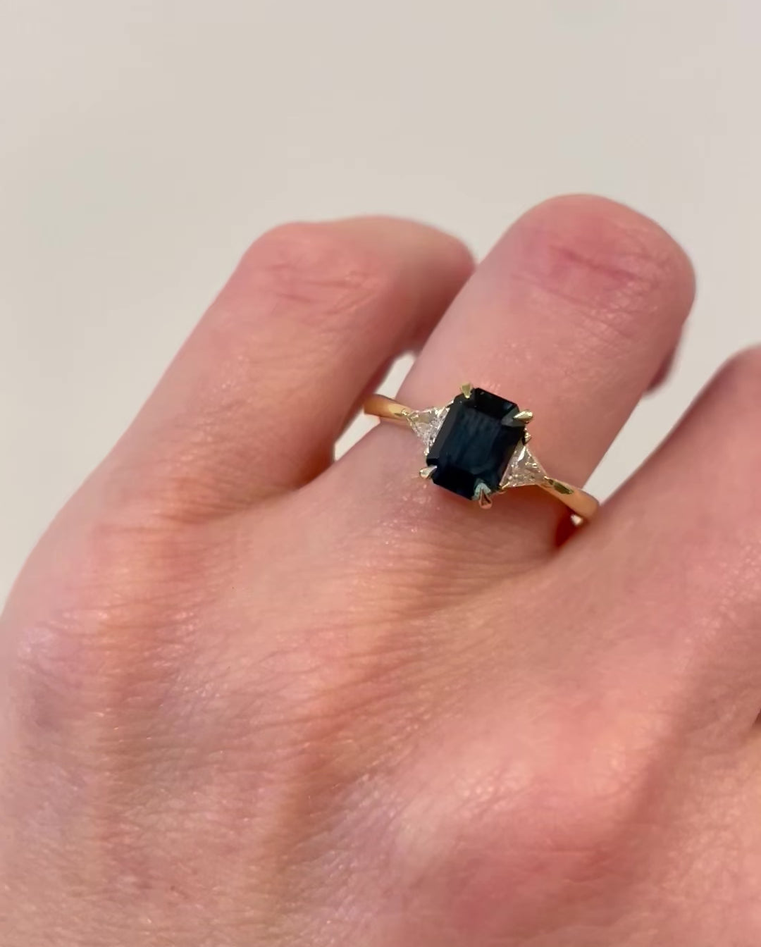 18ct yellow gold emerald cut trilogy ​teal sapphire rings