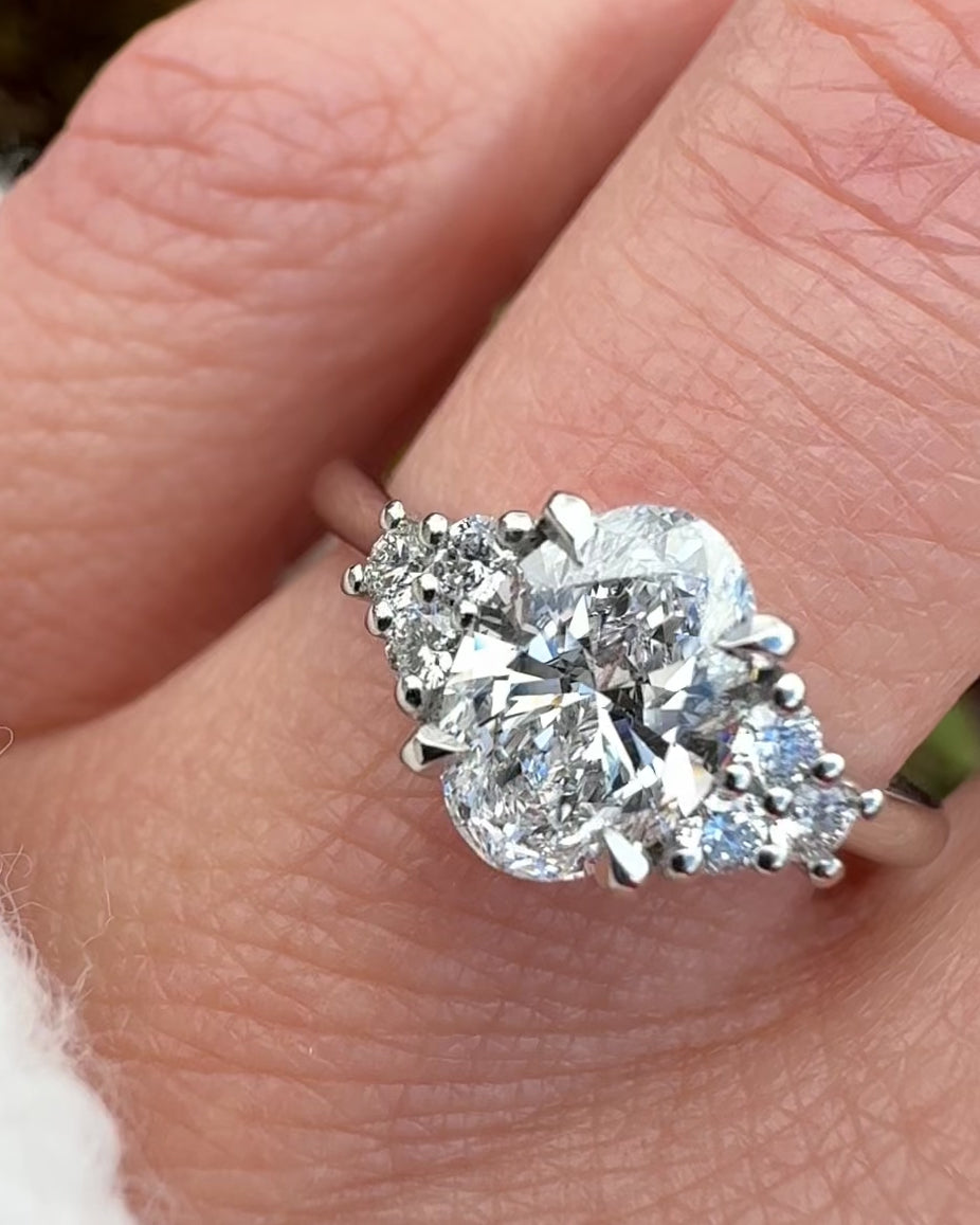 oval lab grown diamond ring in platinum paired with six round brilliant side diamonds