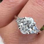 oval lab grown diamond ring in platinum paired with six round brilliant side diamonds