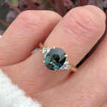 unheated teal blue oval sapphire engagement ring in yellow gold