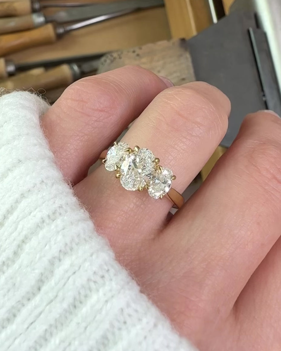 oval diamonds trilogy engagement ring set in 18ct yellow gold