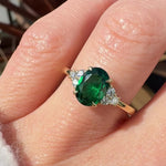 oval emerald yellow gold engagement ring with six round side diamonds