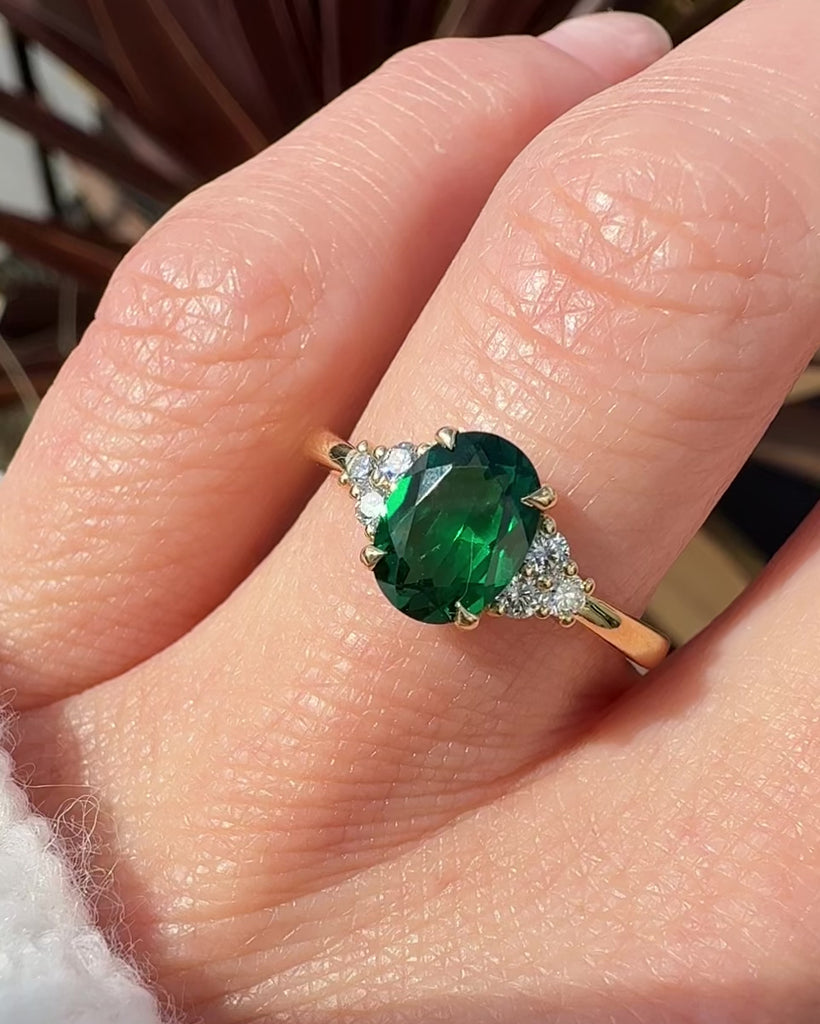 oval emerald yellow gold engagement ring with six round side diamonds