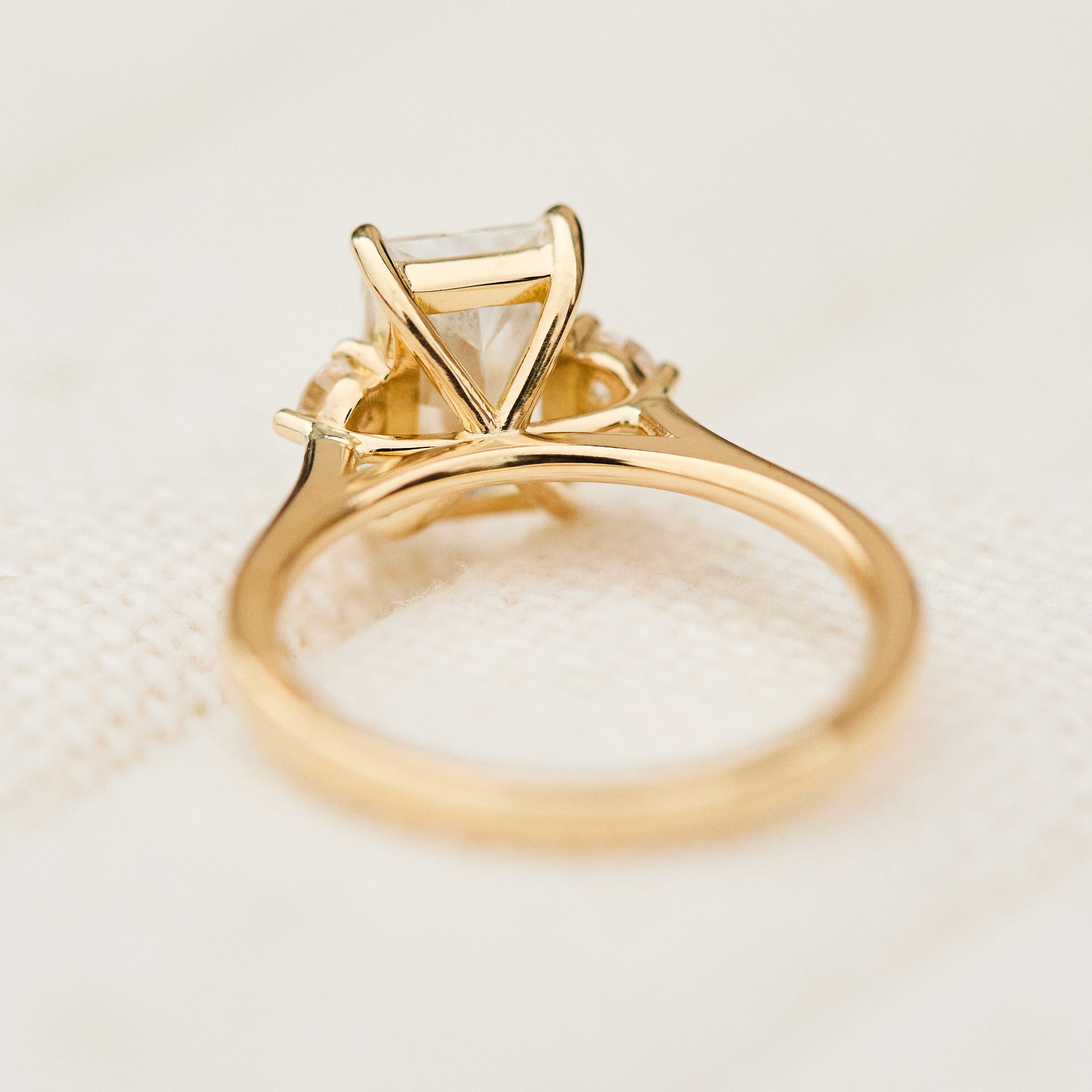 radiant cut lab grown diamond trilogy engagement ring in yellow gold