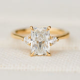 radiant cut lab grown diamond trilogy engagement ring in yellow gold