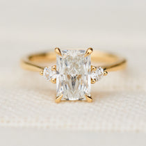radiant cut lab grown diamond trilogy engagement ring in yellow gold