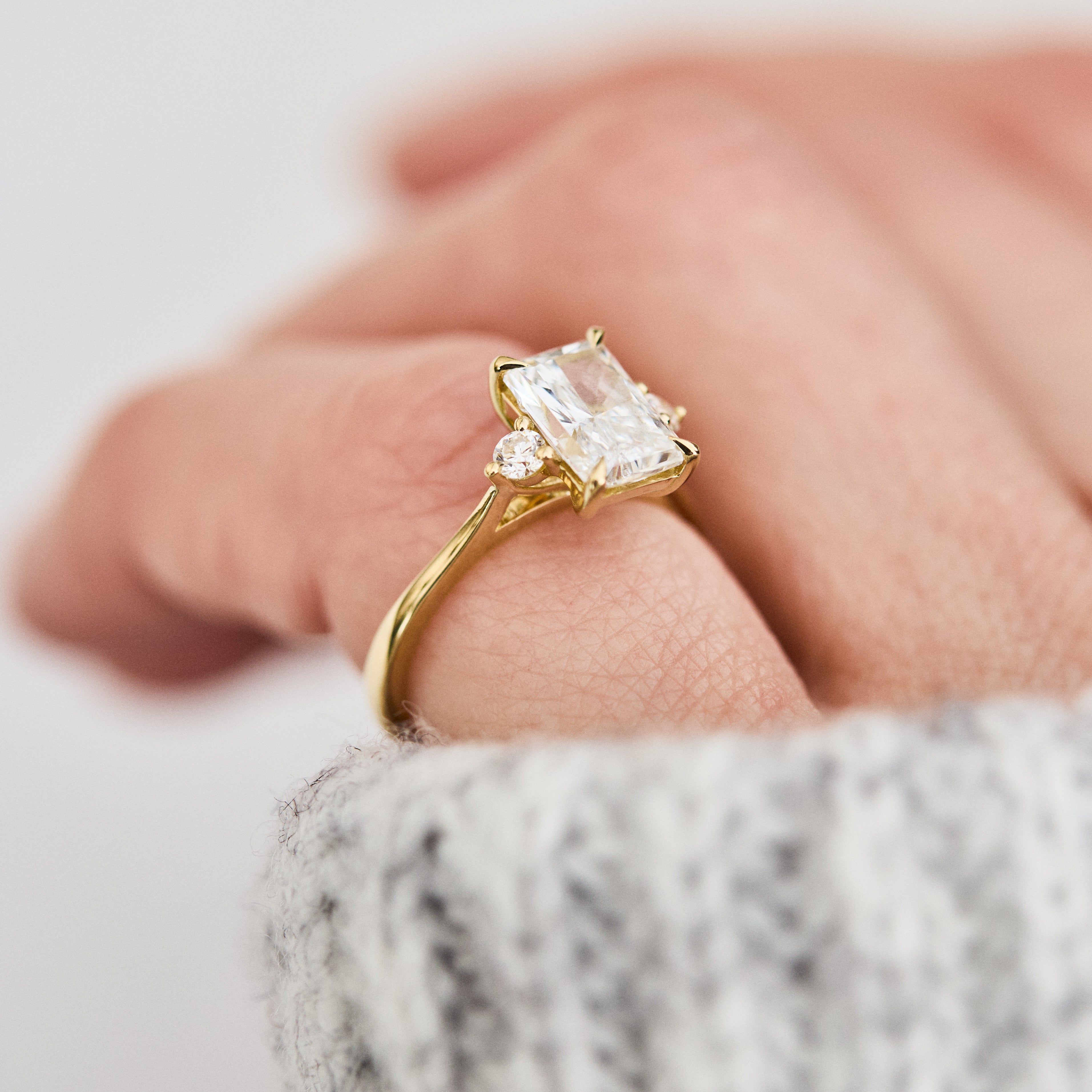 radiant cut lab grown diamond trilogy engagement ring in yellow gold