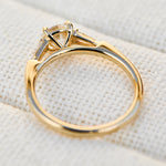 round brilliant cut diamond trilogy engagement ring with tapered baguette shoulders