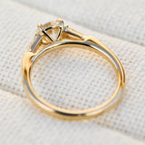 round brilliant cut diamond trilogy engagement ring with tapered baguette shoulders