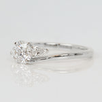 round brilliant cut lab grown diamond and pear shape side diamond engagement ring