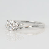 round brilliant cut lab grown diamond and pear shape side diamond engagement ring