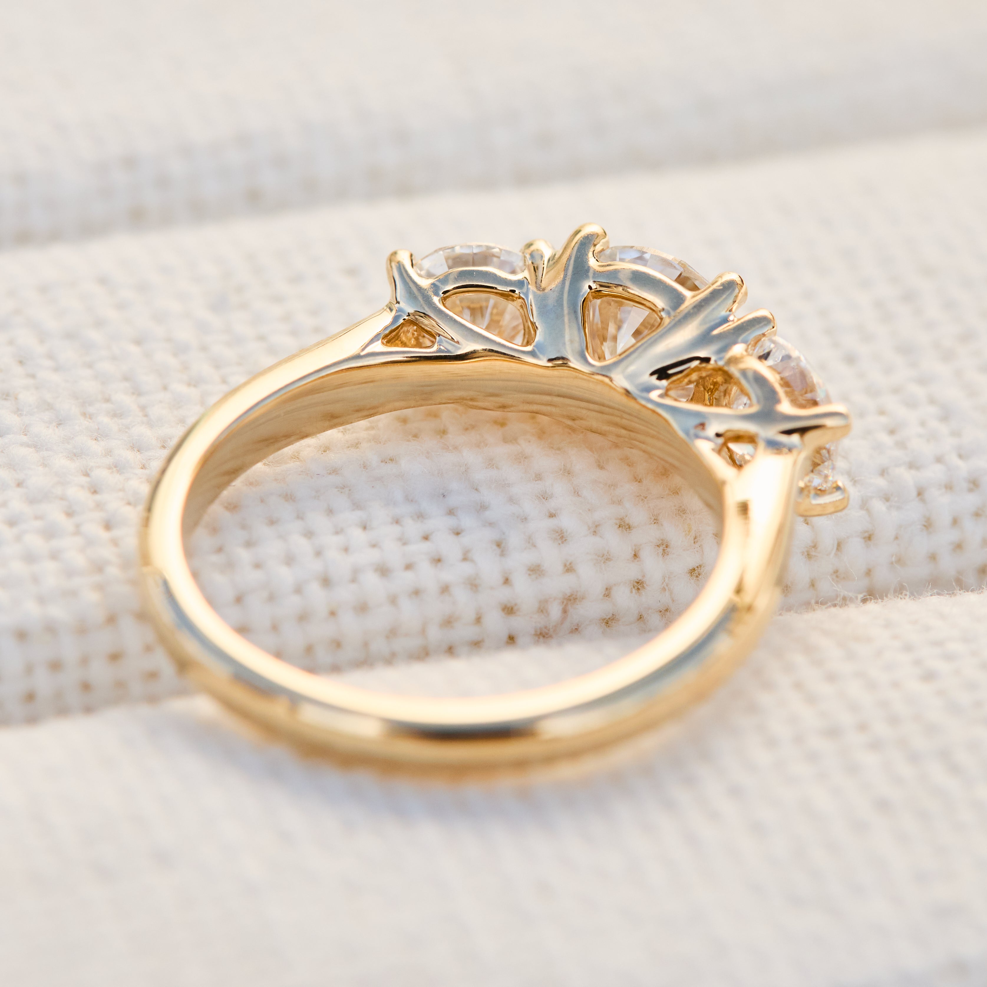 round brilliant cut lab grown diamond yellow gold trilogy engagement ring