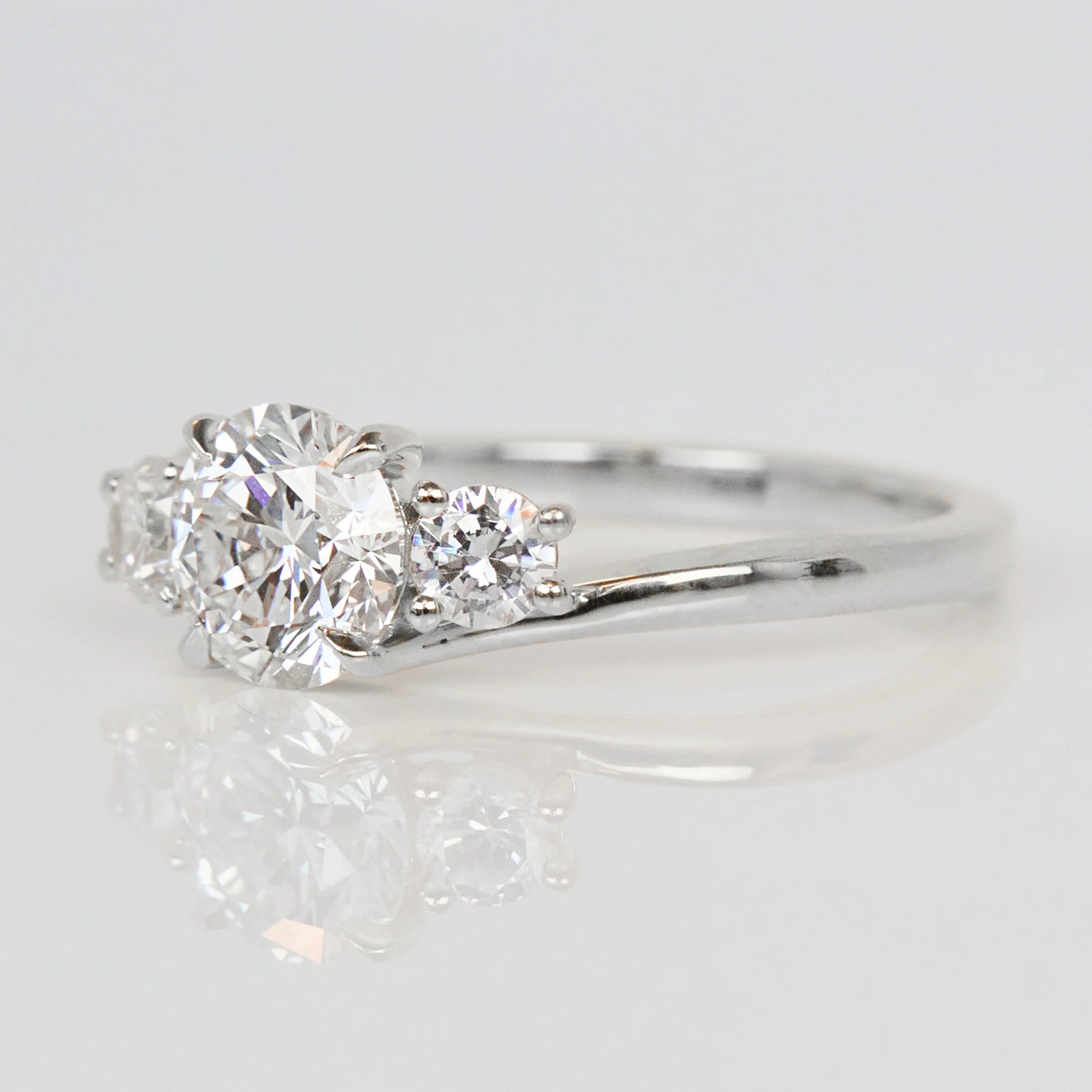 round brilliant cut lab grown diamond three stone engagement ring