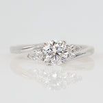 round brilliant cut lab grown diamond with pear shape side diamond engagement ring