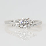 round brilliant cut lab grown diamond with pear shape side diamond engagement ring