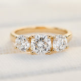 round brilliant cut lab grown diamond yellow gold trilogy engagement ring