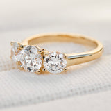 round brilliant cut lab grown diamond yellow gold trilogy engagement ring