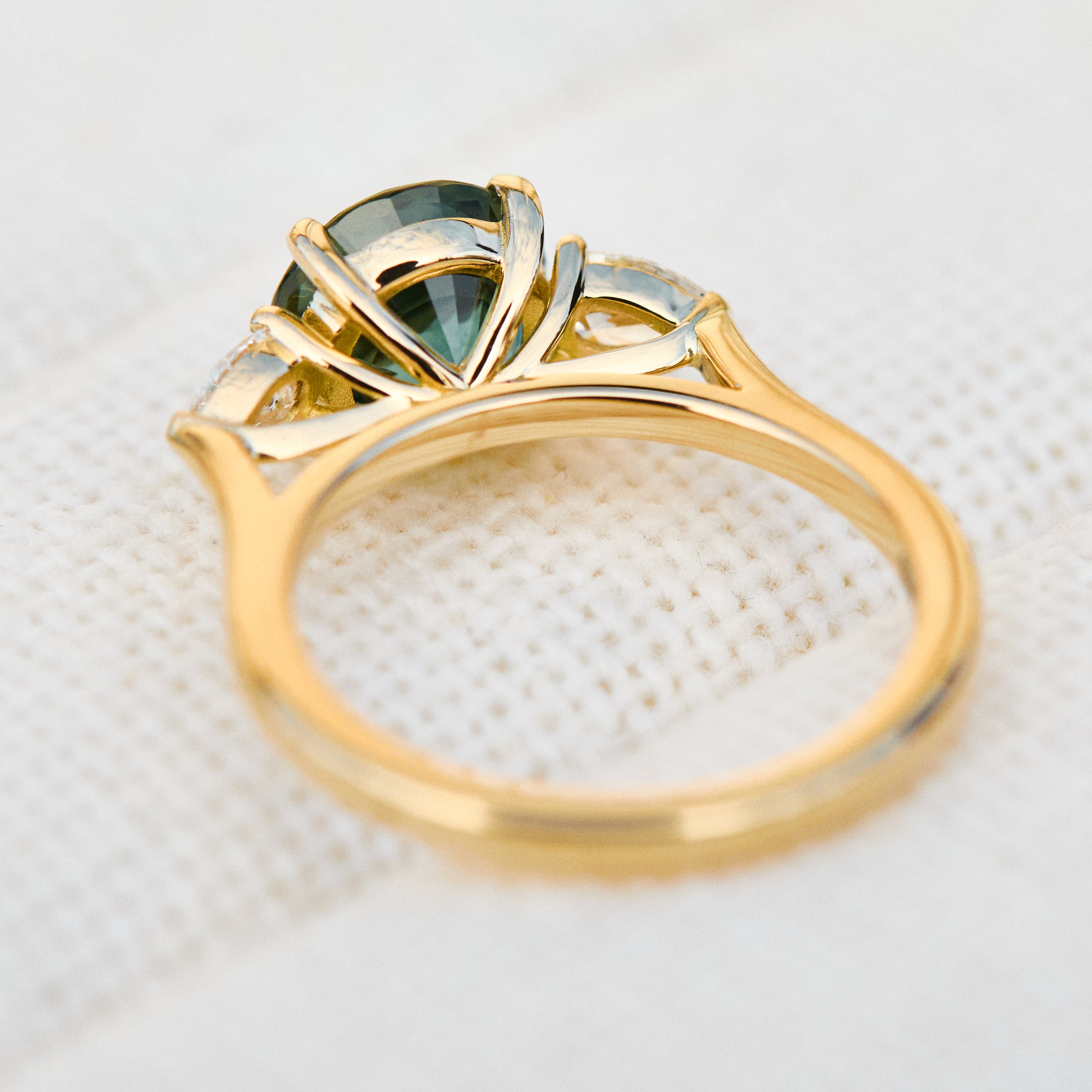 round brilliant cut madagascan teal sapphire trilogy engagement ring