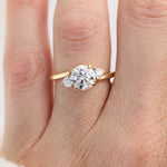 round brilliant cut trilogy diamond engagement ring set in yellow gold