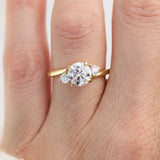 round brilliant cut trilogy diamond engagement ring set in yellow gold