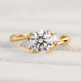 round brilliant cut trilogy diamond engagement ring set in yellow gold