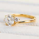 round brilliant cut trilogy diamond engagement ring set in yellow gold