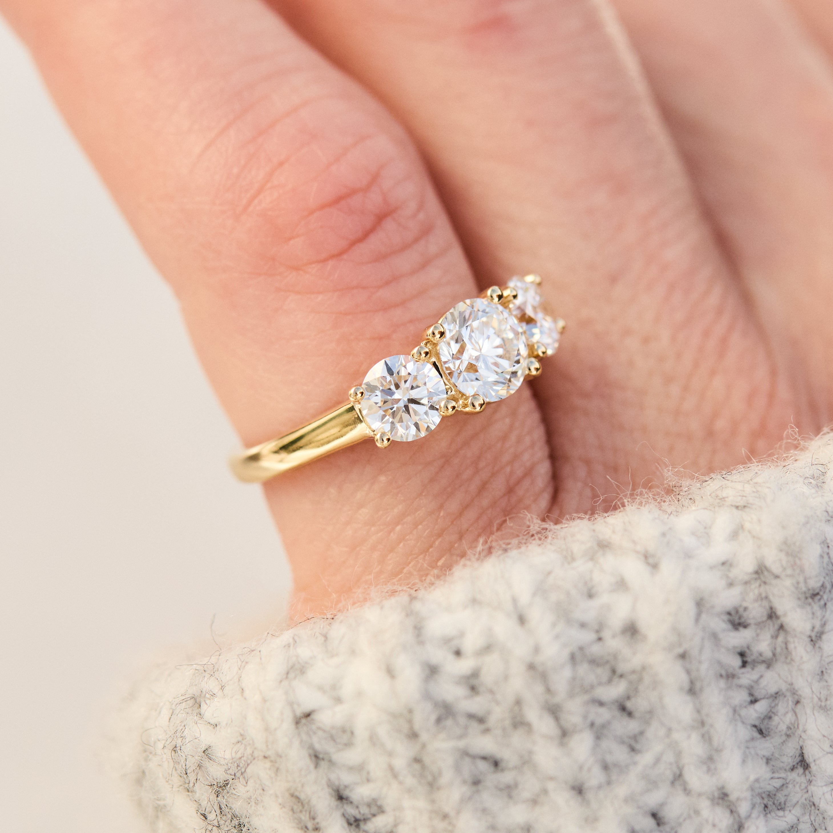 round brilliant cut lab grown diamond yellow gold trilogy engagement ring