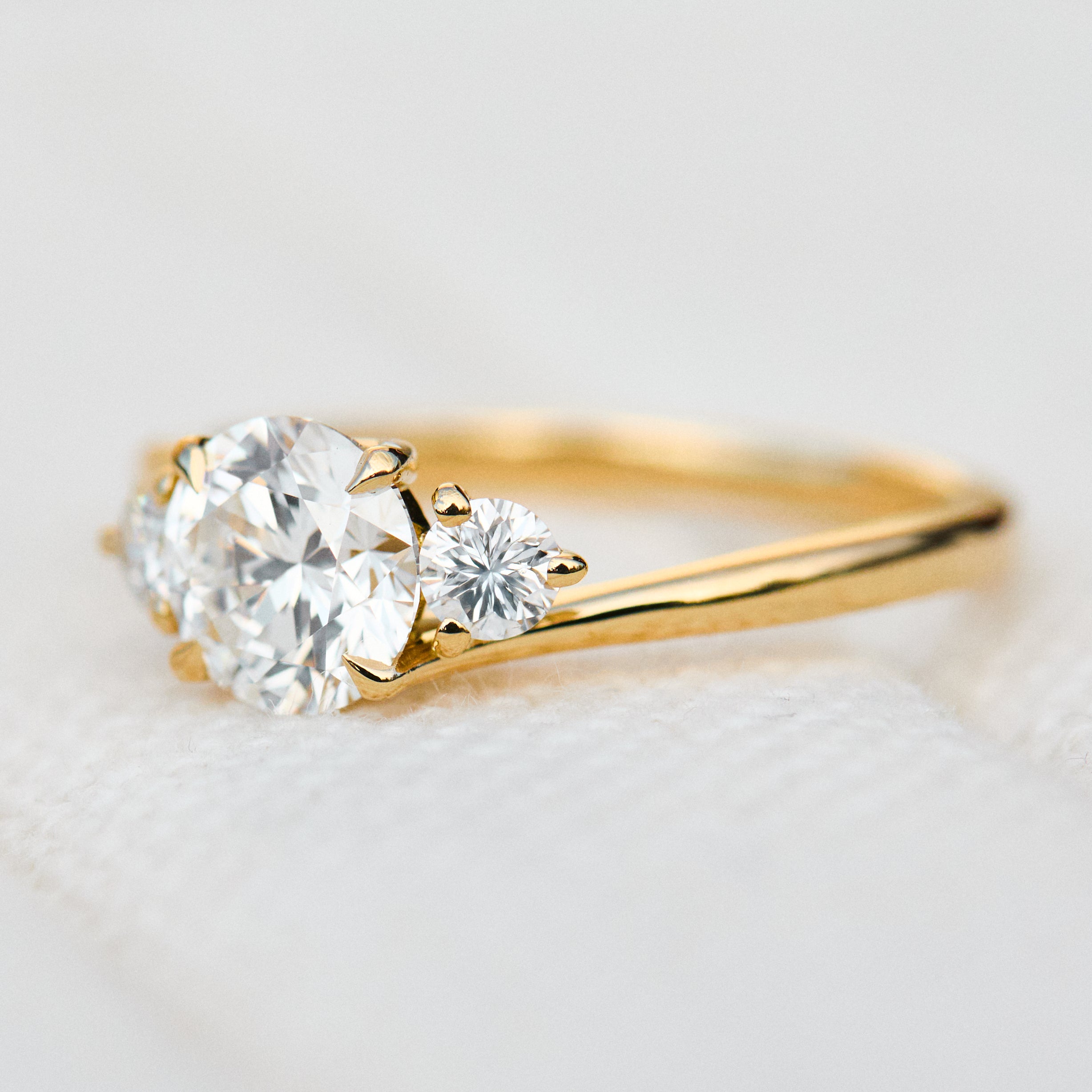 round brilliant lab grown diamond trilogy engagement ring in yellow gold