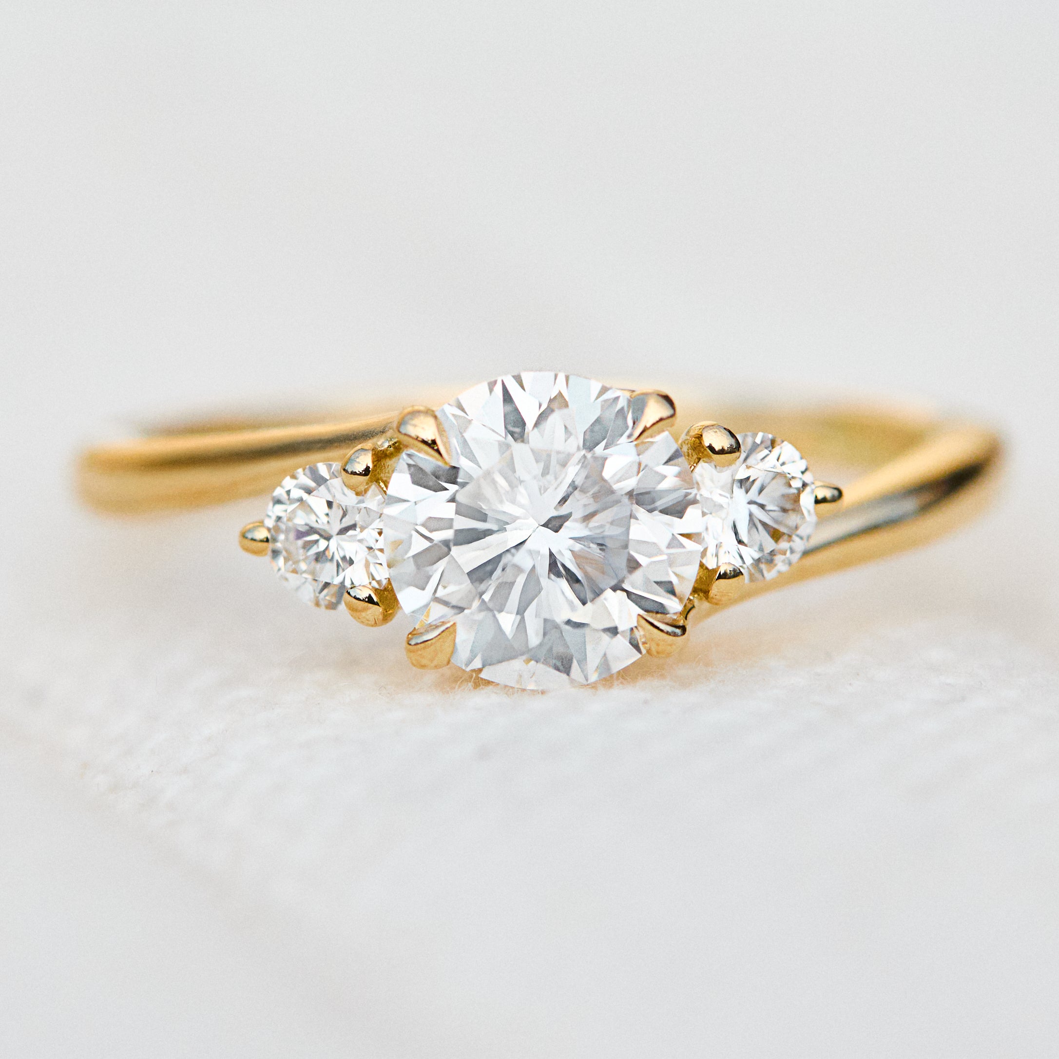 round brilliant lab grown diamond trilogy engagement ring in yellow gold