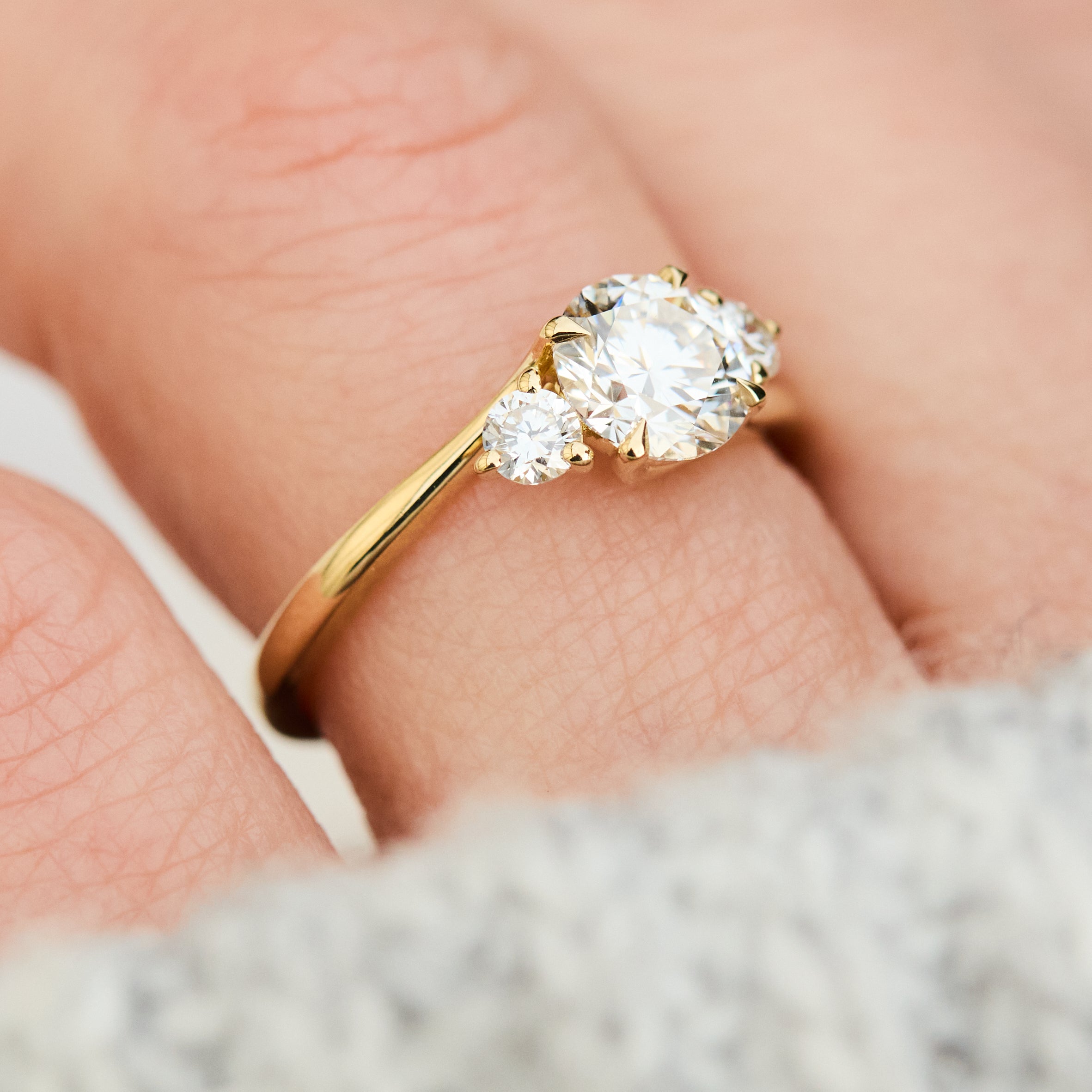 round brilliant lab grown diamond trilogy engagement ring in yellow gold