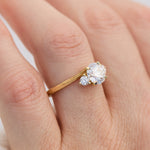 round brilliant cut trilogy diamond engagement ring set in yellow gold