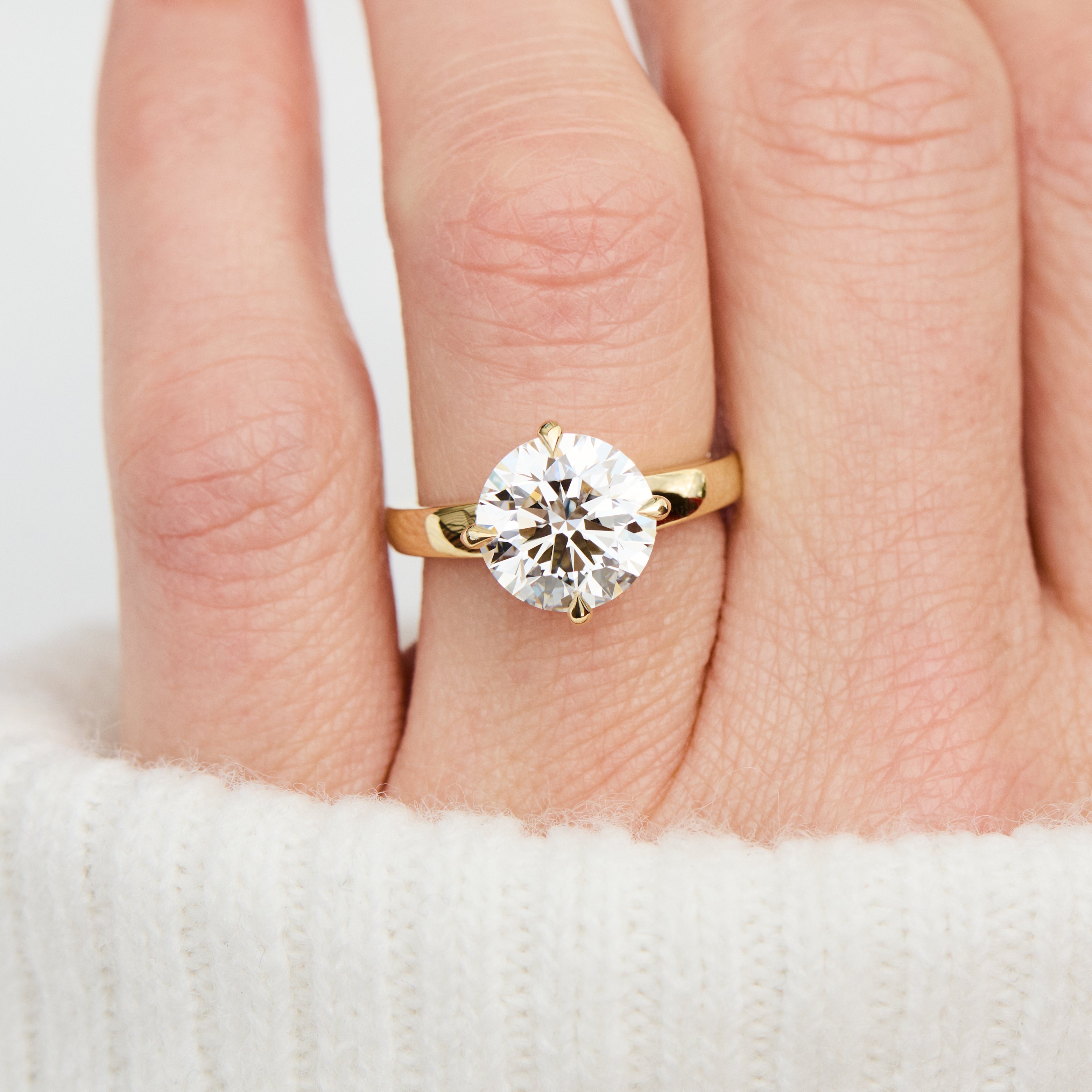 round lab grown diamond solitaire engagement ring in yellow gold