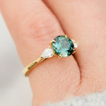 round brilliant cut madagascan teal sapphire trilogy engagement ring
