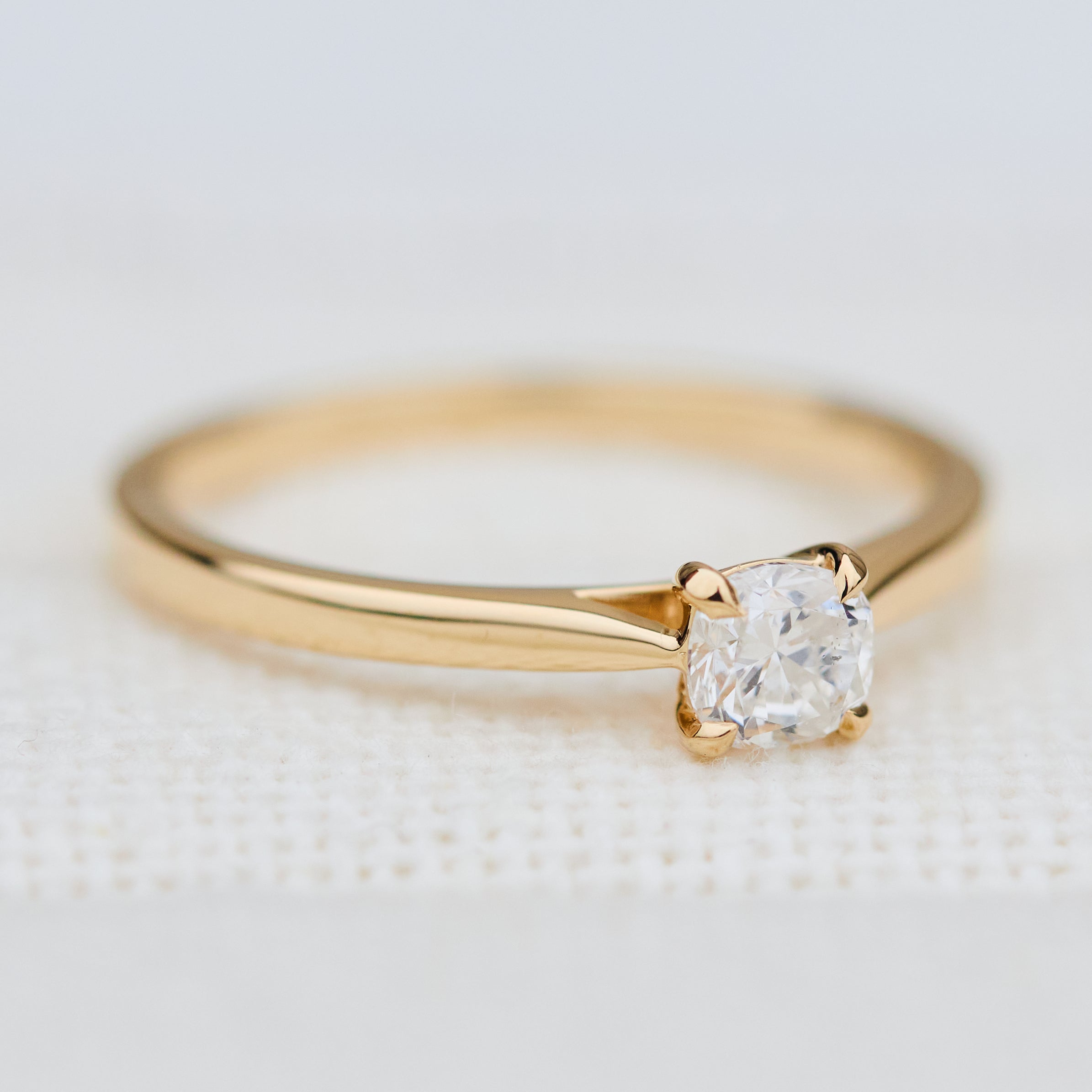 salt and pepper cushion cut diamond solitaire engagement ring in yellow gold