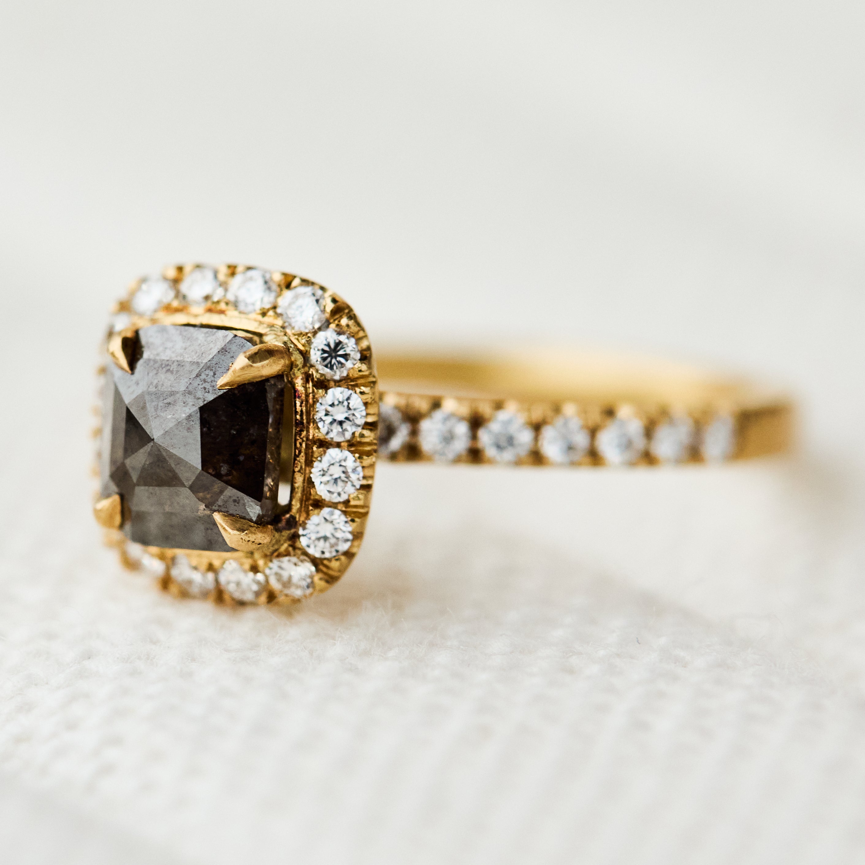 salt and pepper halo engagement ring in yellow gold