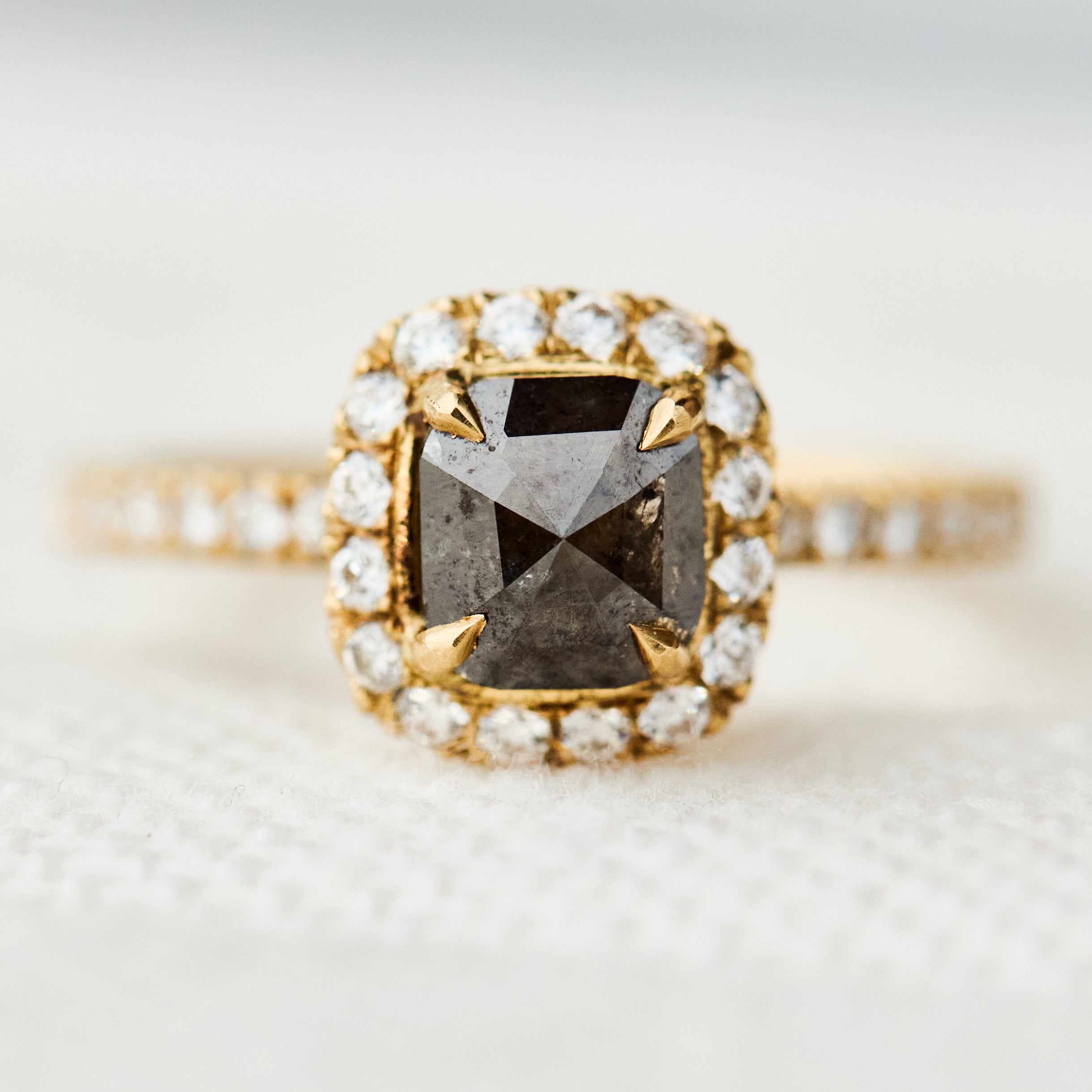 salt and pepper halo engagement ring in yellow gold