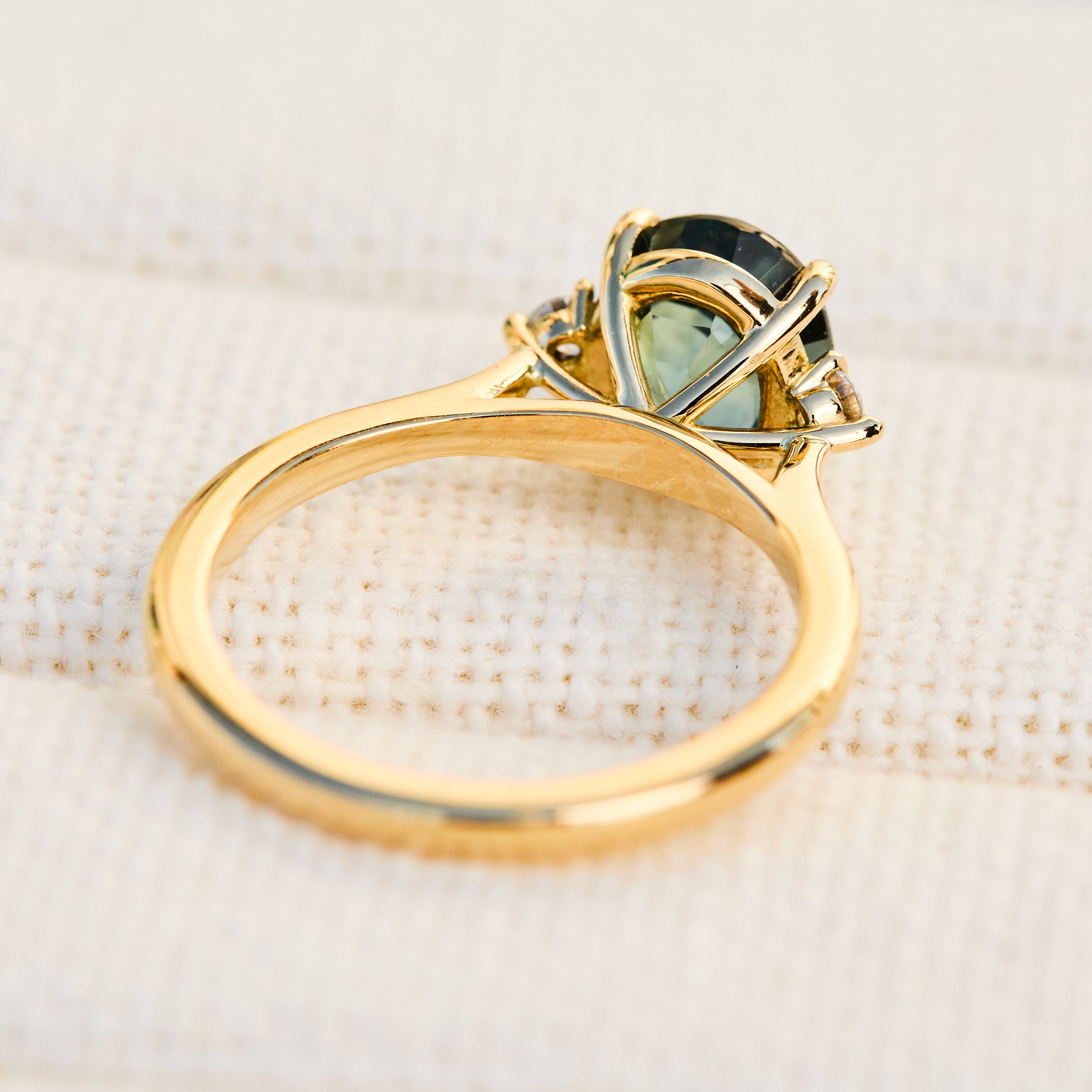 oval sapphire trilogy engagement ring in yellow gold