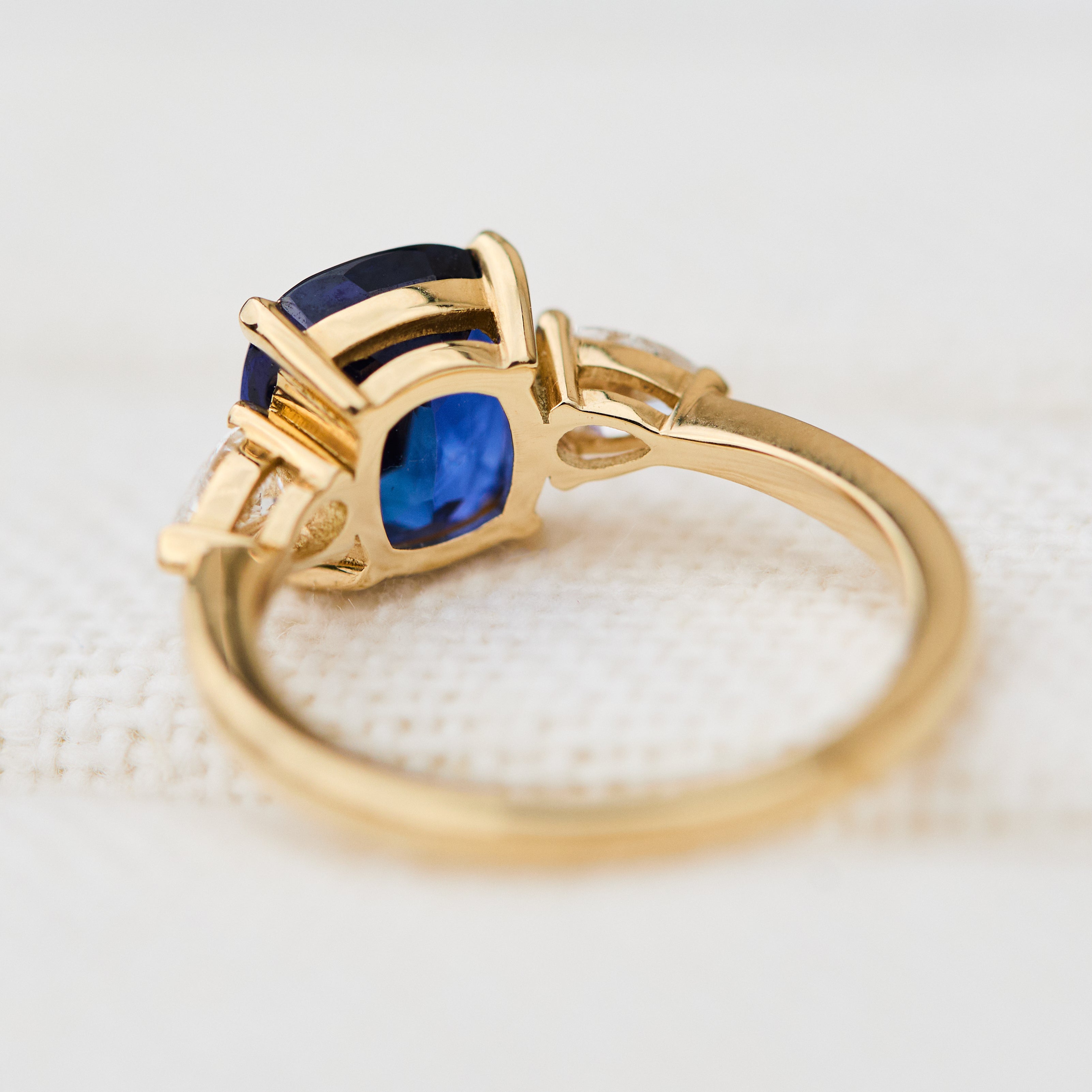 sri lankan blue sapphire trilogy engagement ring in yellow gold