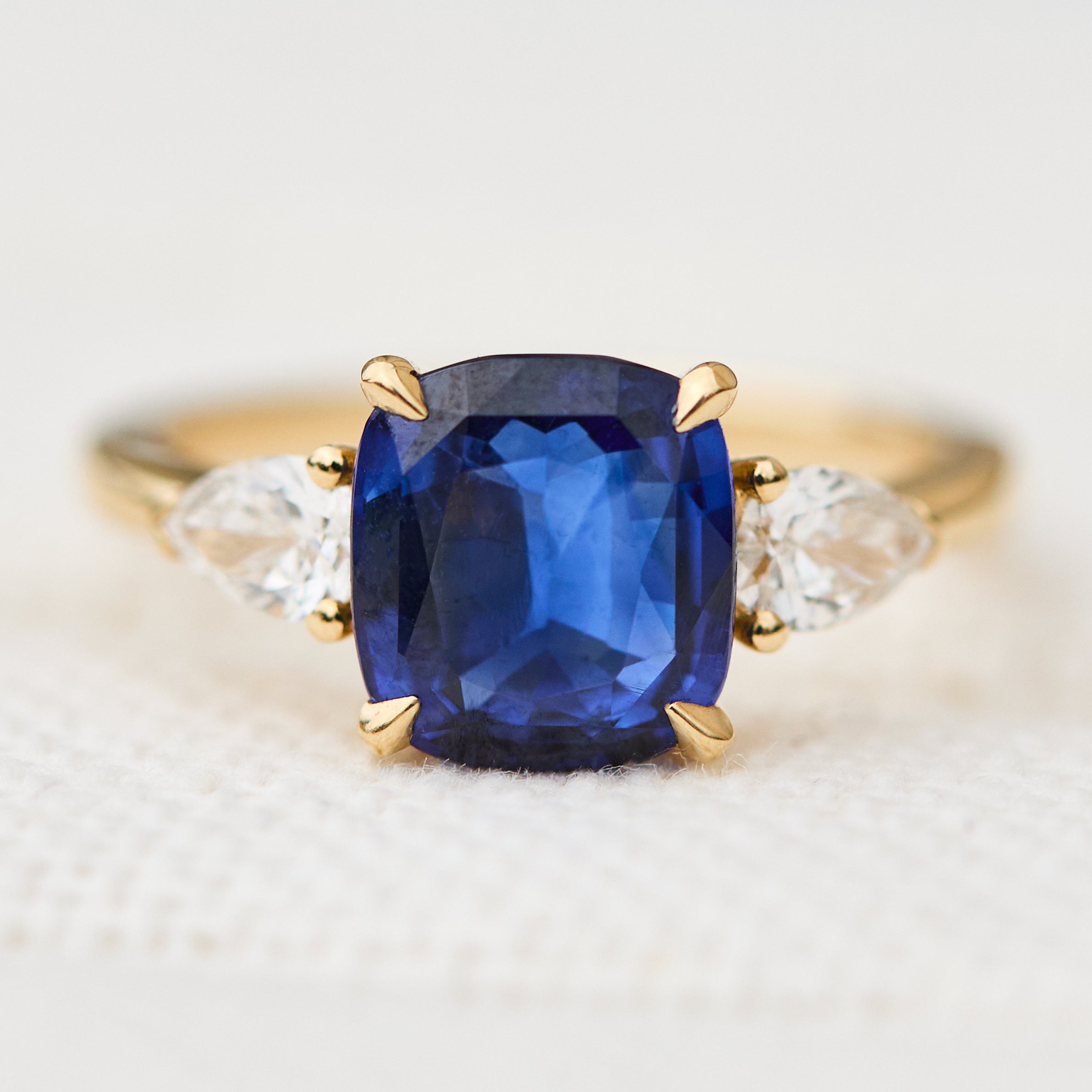sri lankan blue sapphire trilogy engagement ring in yellow gold